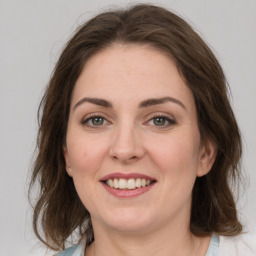 Joyful white young-adult female with medium  brown hair and green eyes