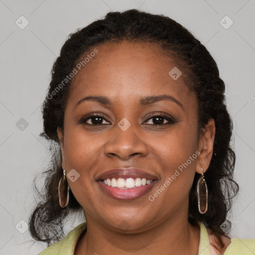 Joyful black young-adult female with medium  brown hair and brown eyes