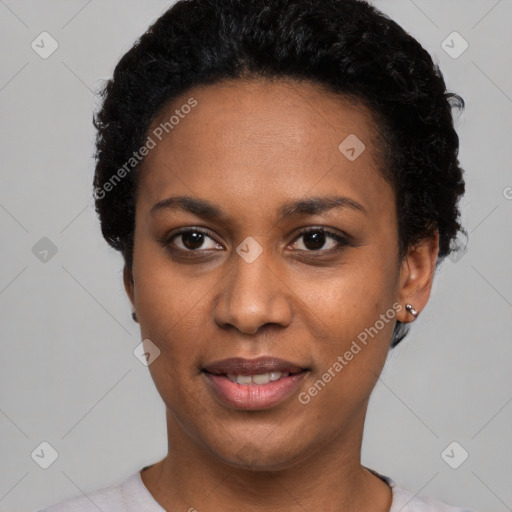 Joyful black young-adult female with short  black hair and brown eyes