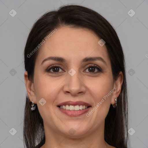 Joyful white adult female with long  brown hair and brown eyes