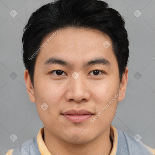 Joyful asian young-adult male with short  black hair and brown eyes