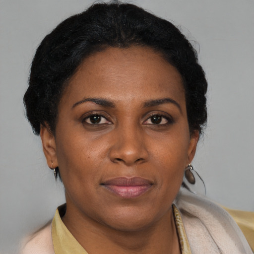 Joyful black adult female with short  brown hair and brown eyes