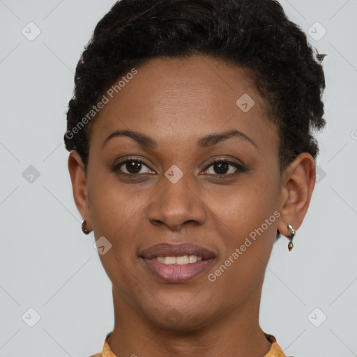 Joyful black young-adult female with short  brown hair and brown eyes