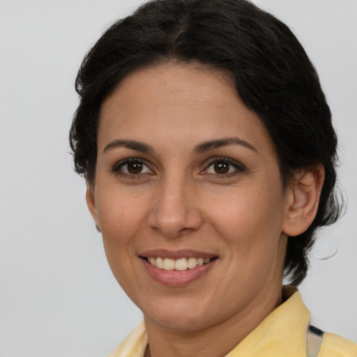 Joyful white adult female with short  brown hair and brown eyes
