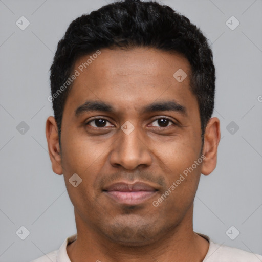 Joyful black young-adult male with short  black hair and brown eyes