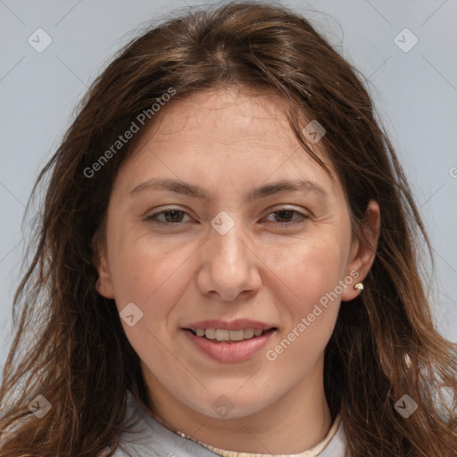 Joyful white adult female with long  brown hair and brown eyes