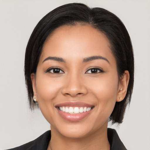 Joyful latino young-adult female with long  black hair and brown eyes