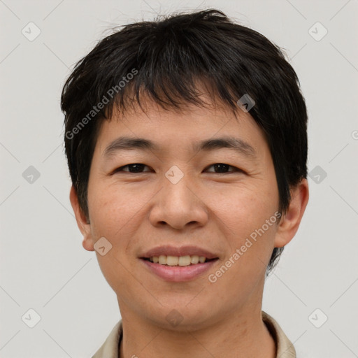 Joyful asian young-adult male with short  brown hair and brown eyes