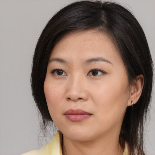 Neutral asian young-adult female with medium  brown hair and brown eyes
