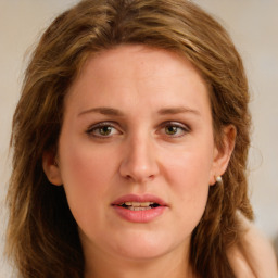 Joyful white young-adult female with long  brown hair and green eyes