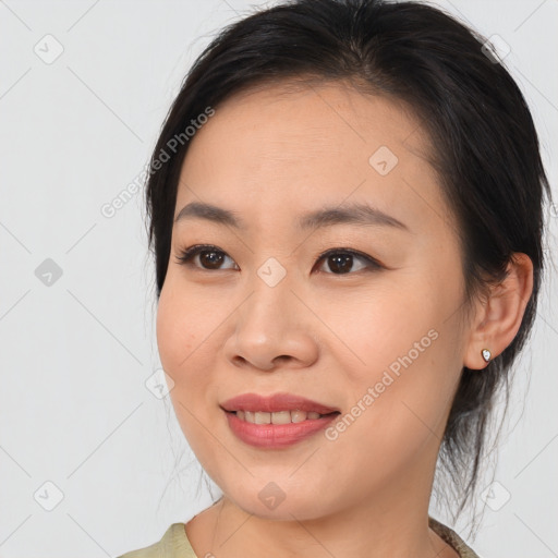 Joyful asian young-adult female with medium  brown hair and brown eyes