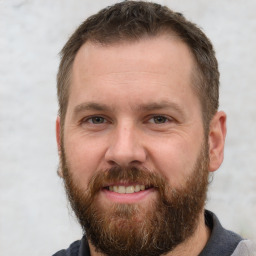 Joyful white adult male with short  brown hair and brown eyes