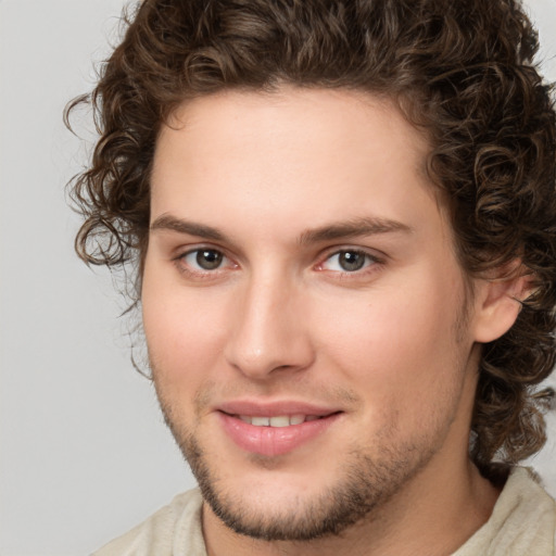 Joyful white young-adult male with medium  brown hair and brown eyes