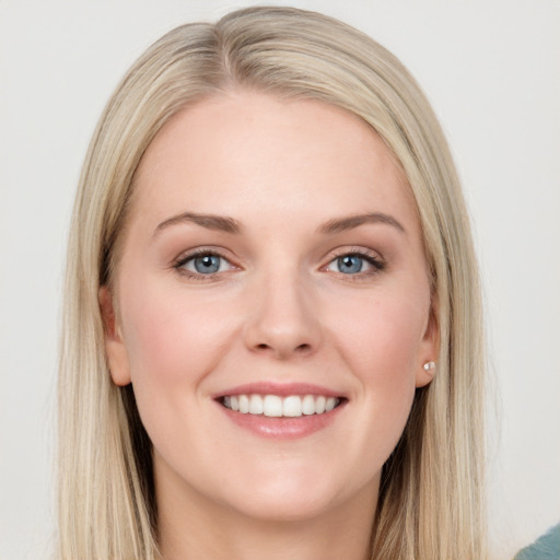 Joyful white young-adult female with long  brown hair and blue eyes