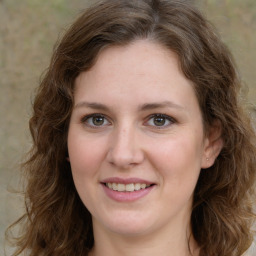 Joyful white young-adult female with medium  brown hair and green eyes