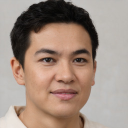 Joyful latino young-adult male with short  brown hair and brown eyes