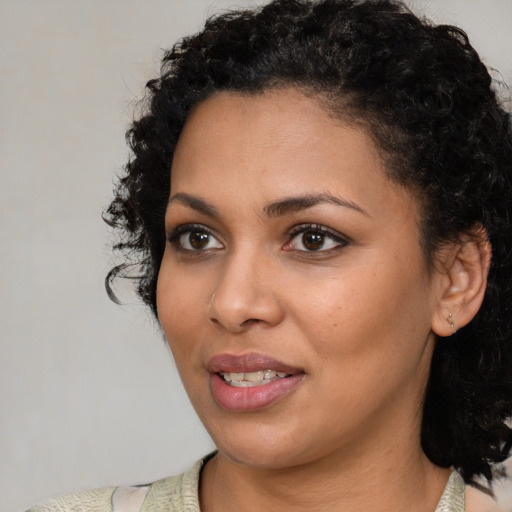 Joyful latino young-adult female with short  black hair and brown eyes