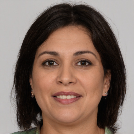 Joyful white adult female with medium  brown hair and brown eyes