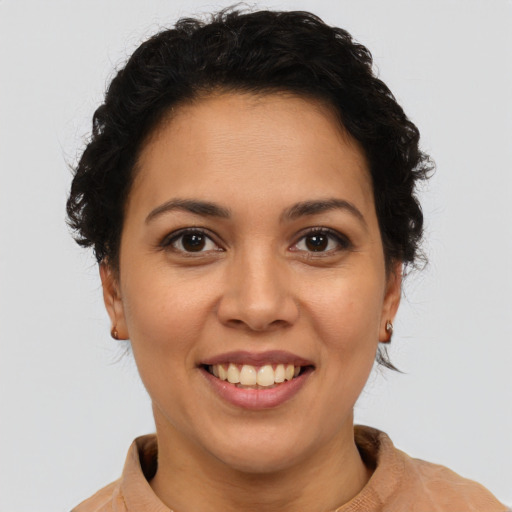 Joyful latino young-adult female with short  brown hair and brown eyes
