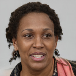 Joyful black adult female with medium  brown hair and brown eyes