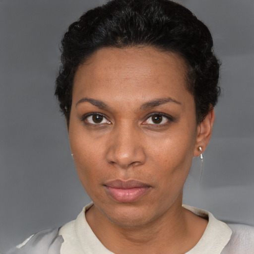 Neutral black adult female with short  black hair and brown eyes