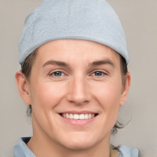 Joyful white young-adult female with short  brown hair and grey eyes