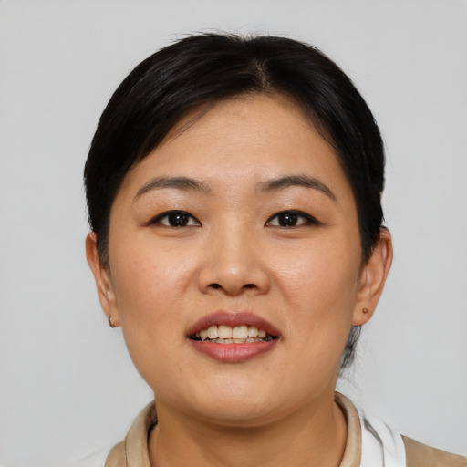 Joyful asian young-adult female with short  brown hair and brown eyes