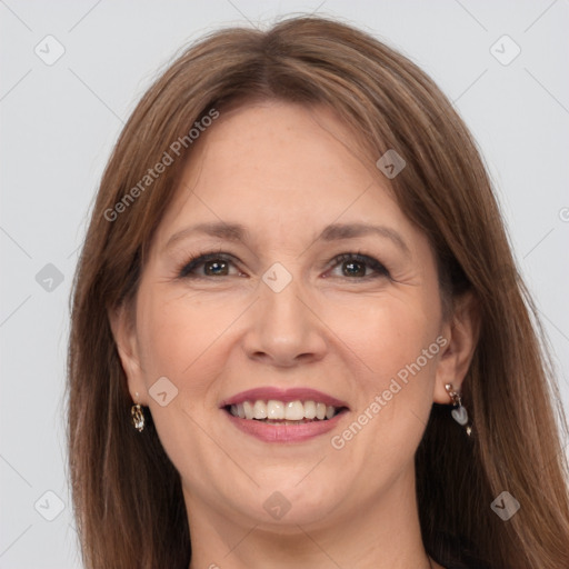 Joyful white adult female with long  brown hair and grey eyes