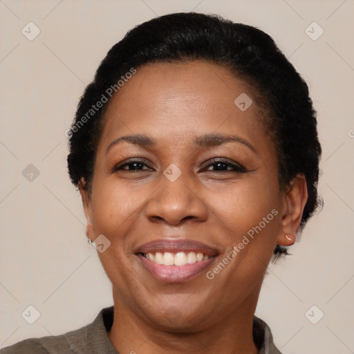 Joyful black adult female with short  black hair and brown eyes