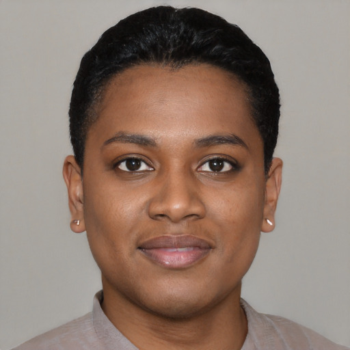 Joyful black young-adult female with short  black hair and brown eyes