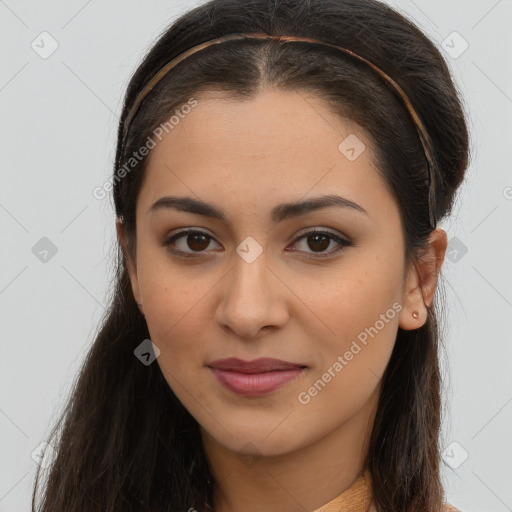 Joyful latino young-adult female with long  brown hair and brown eyes