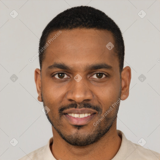 Joyful black young-adult male with short  black hair and brown eyes