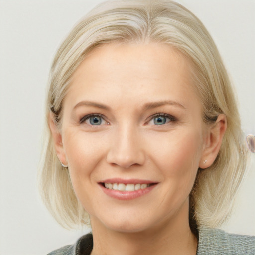 Joyful white young-adult female with medium  blond hair and blue eyes