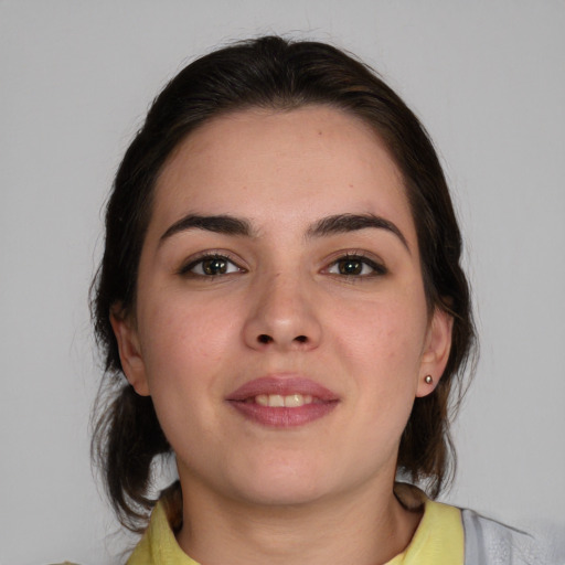 Joyful white young-adult female with medium  brown hair and brown eyes