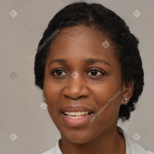 Joyful black young-adult female with short  black hair and brown eyes