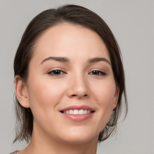 Joyful white young-adult female with medium  brown hair and brown eyes