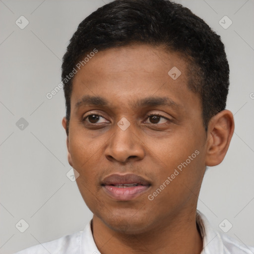 Joyful latino young-adult male with short  black hair and brown eyes