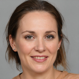 Joyful white adult female with medium  brown hair and brown eyes