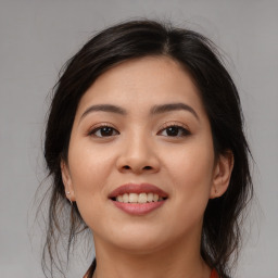 Joyful asian young-adult female with medium  brown hair and brown eyes