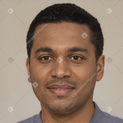 Joyful black young-adult male with short  black hair and brown eyes