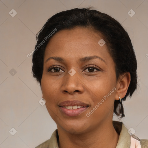 Joyful black adult female with medium  brown hair and brown eyes