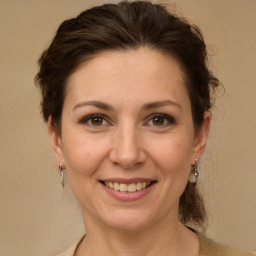 Joyful white adult female with medium  brown hair and brown eyes