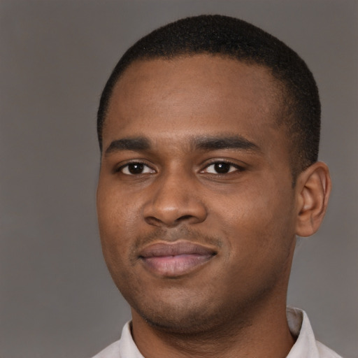 Joyful black young-adult male with short  brown hair and brown eyes