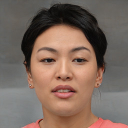 Joyful asian young-adult female with short  brown hair and brown eyes