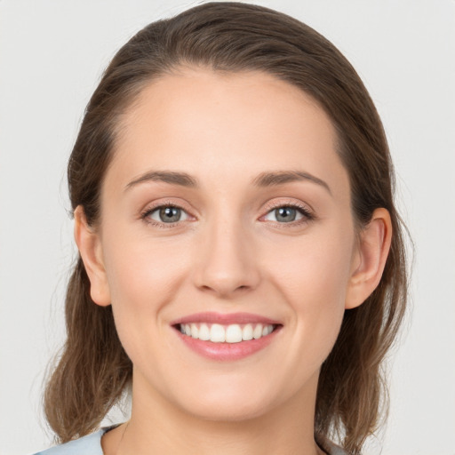 Joyful white young-adult female with long  brown hair and grey eyes