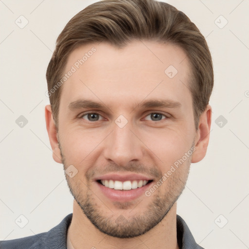 Joyful white young-adult male with short  brown hair and grey eyes