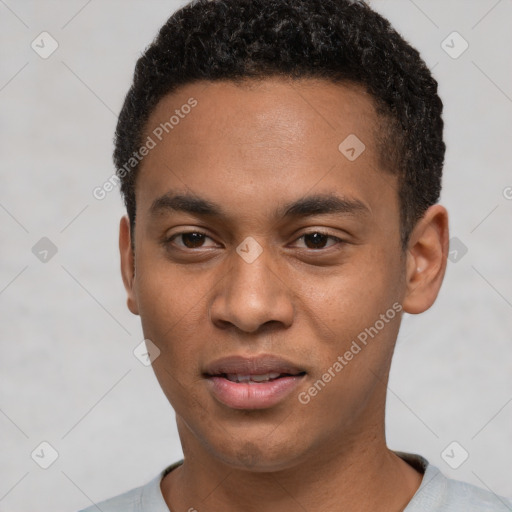 Joyful black young-adult male with short  black hair and brown eyes