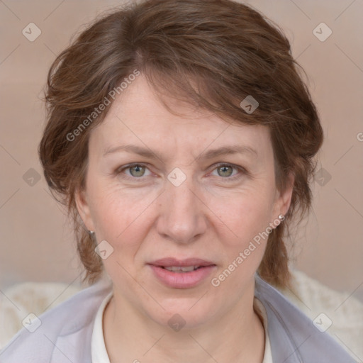 Joyful white adult female with medium  brown hair and blue eyes