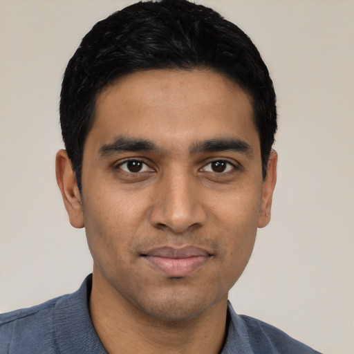Joyful latino young-adult male with short  black hair and brown eyes