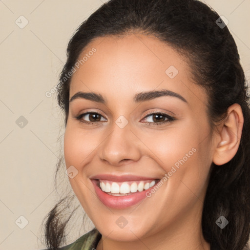 Joyful white young-adult female with long  brown hair and brown eyes